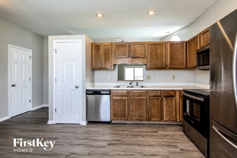 A kitchen with wooden cabinets and stainless steel appliances.
