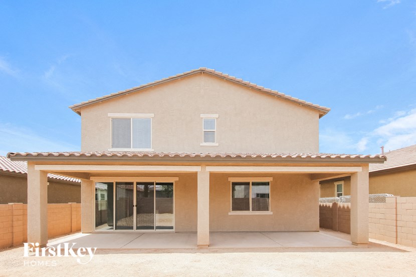 a beige house with a garage and a blue sky