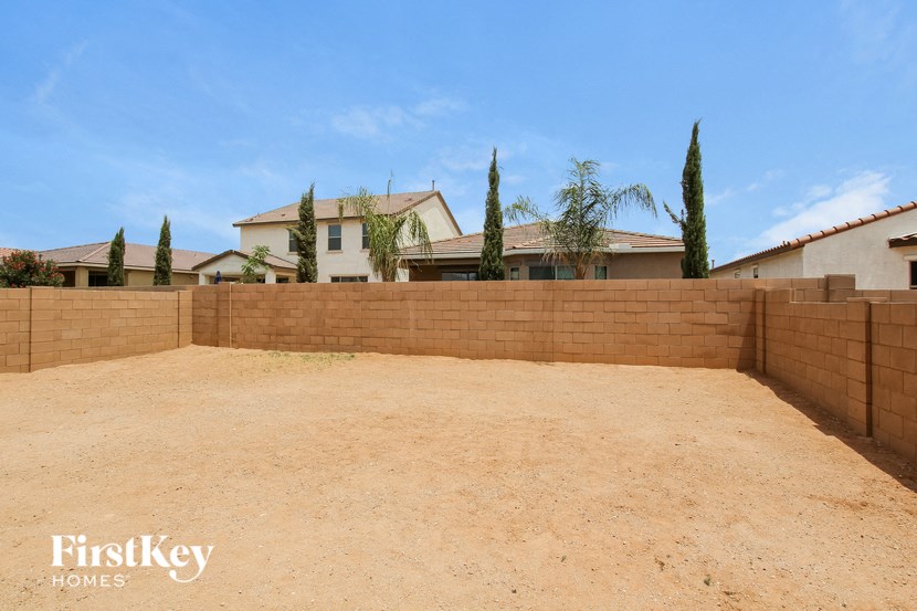 a retaining wall with a house in the background