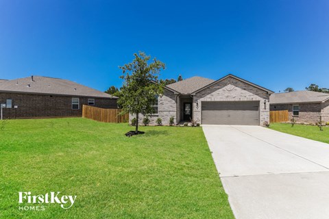 a house with a lawn and a driveway