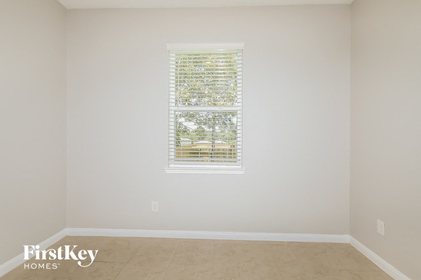 a empty room with a window and white walls