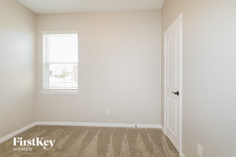 a bedroom with a door and a window
