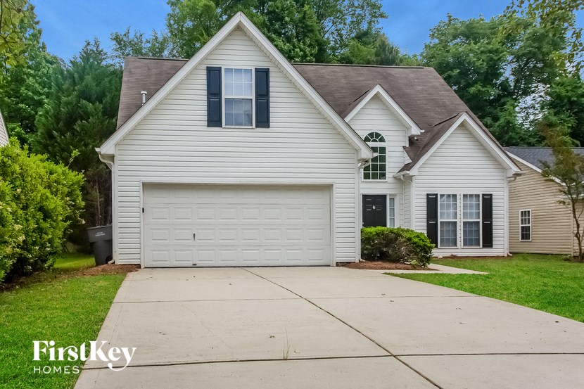 A house with a garage and a driveway is for sale.