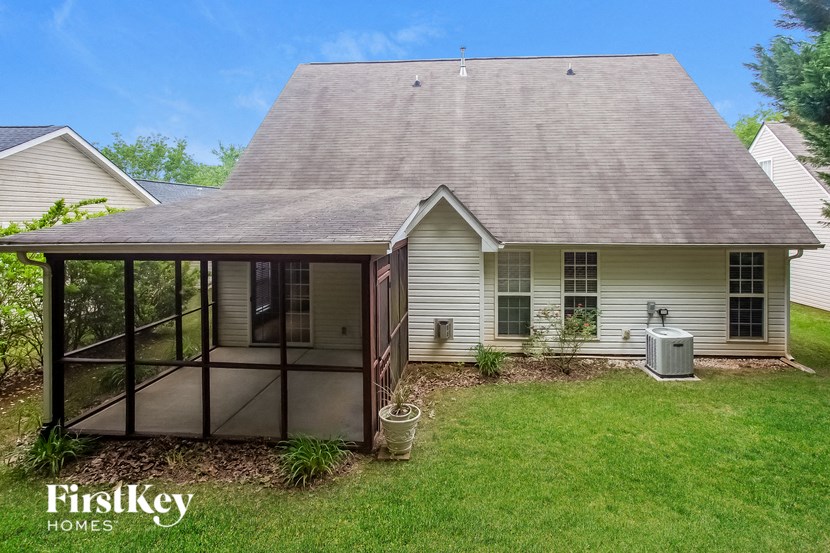 A house with a sunroom attached to it.