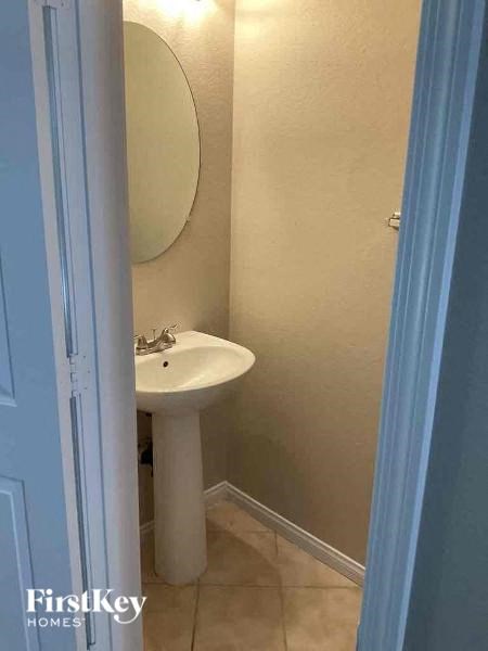 a bathroom with a white sink and a mirror