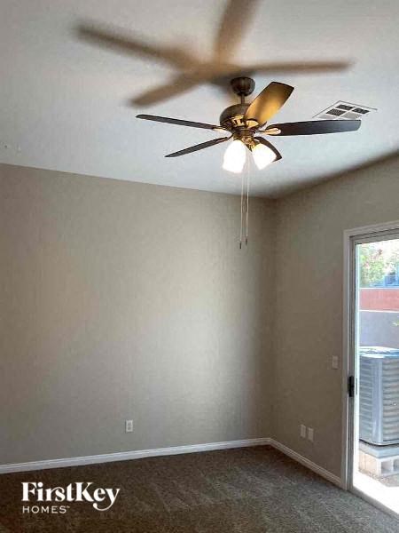 a bedroom with a ceiling fan and a window