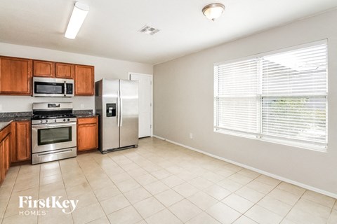 A kitchen with wooden cabinets and stainless steel appliances.