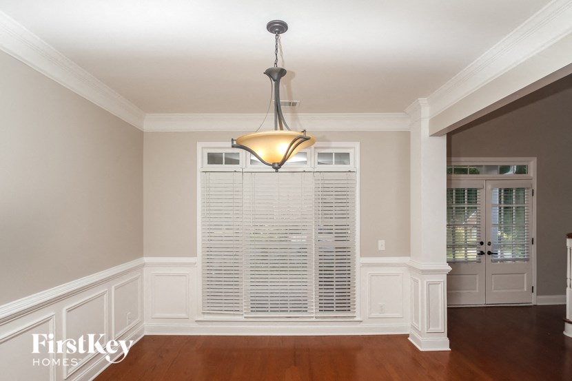 A well-lit room with a chandelier hanging from the ceiling.