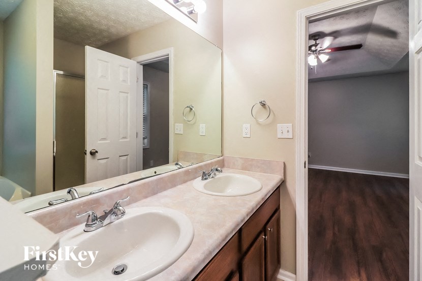 A bathroom with a double sink and a mirror.
