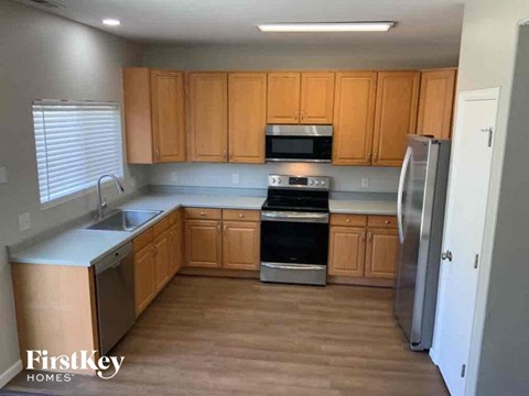 A kitchen with wooden cabinets and stainless steel appliances.