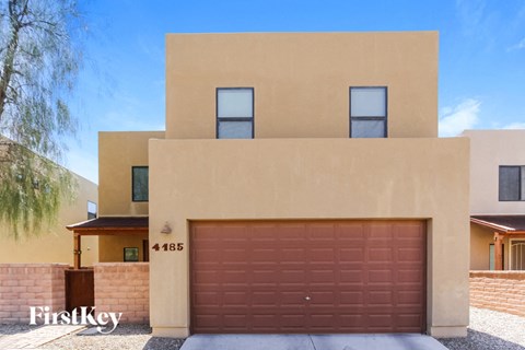 a house with a garage door in front of it