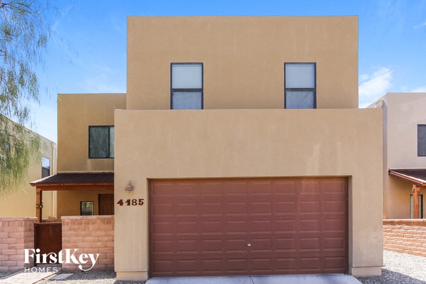 a house with a garage door in front of it