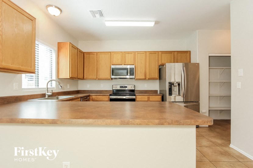 a kitchen with wooden cabinets and a large counter top