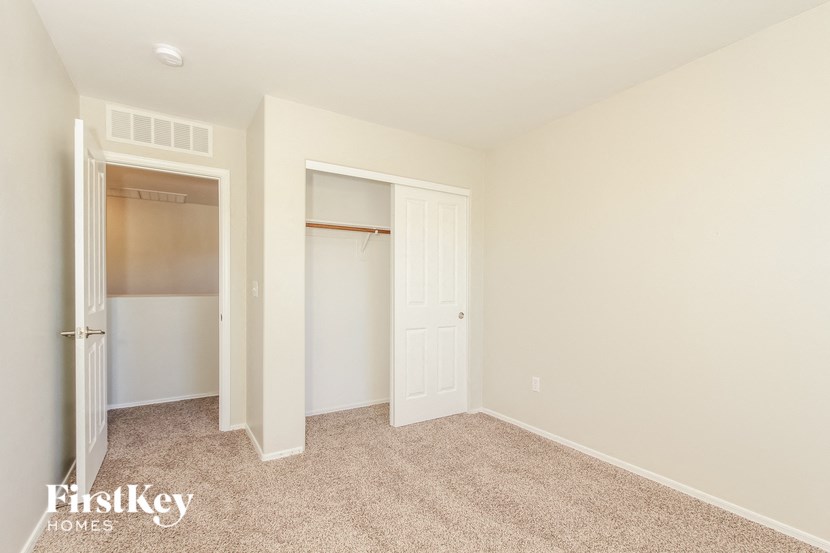 a bedroom with a closet and a door to a closet