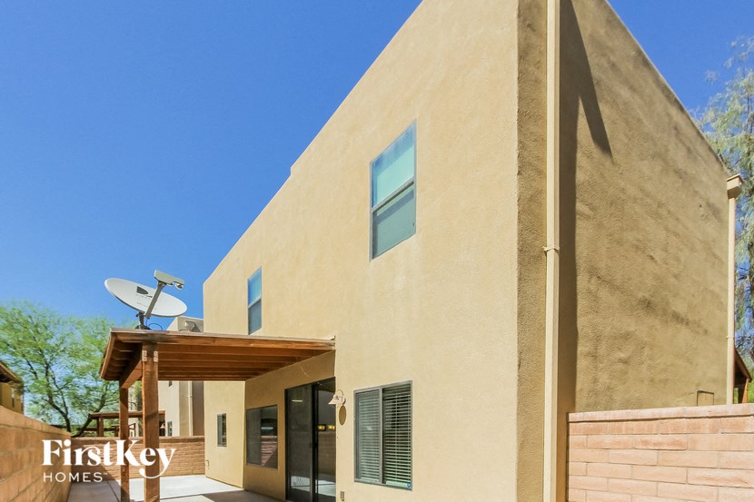 the exterior of a house with a satellite dish on the roof