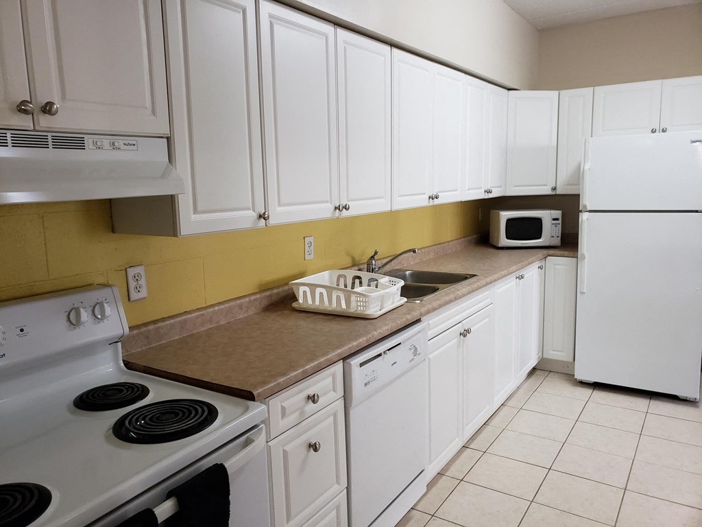a kitchen with white appliances and white cabinets