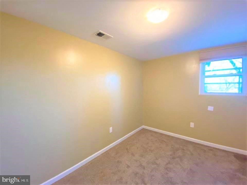 a empty room with a window and carpet