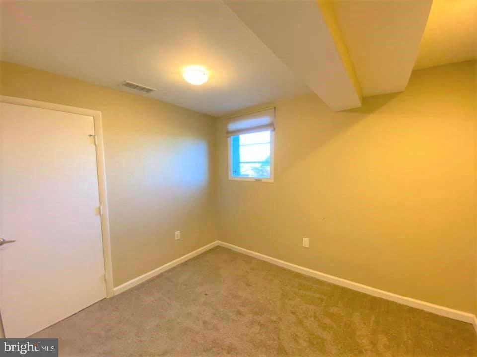 a empty room with a door and a window