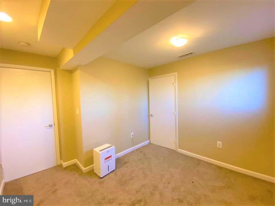 a empty room with white walls and a white box on the floor