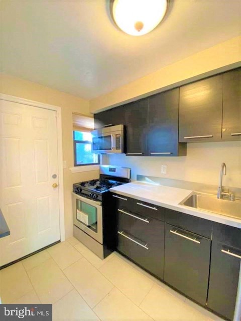 a kitchen with a stove and a sink