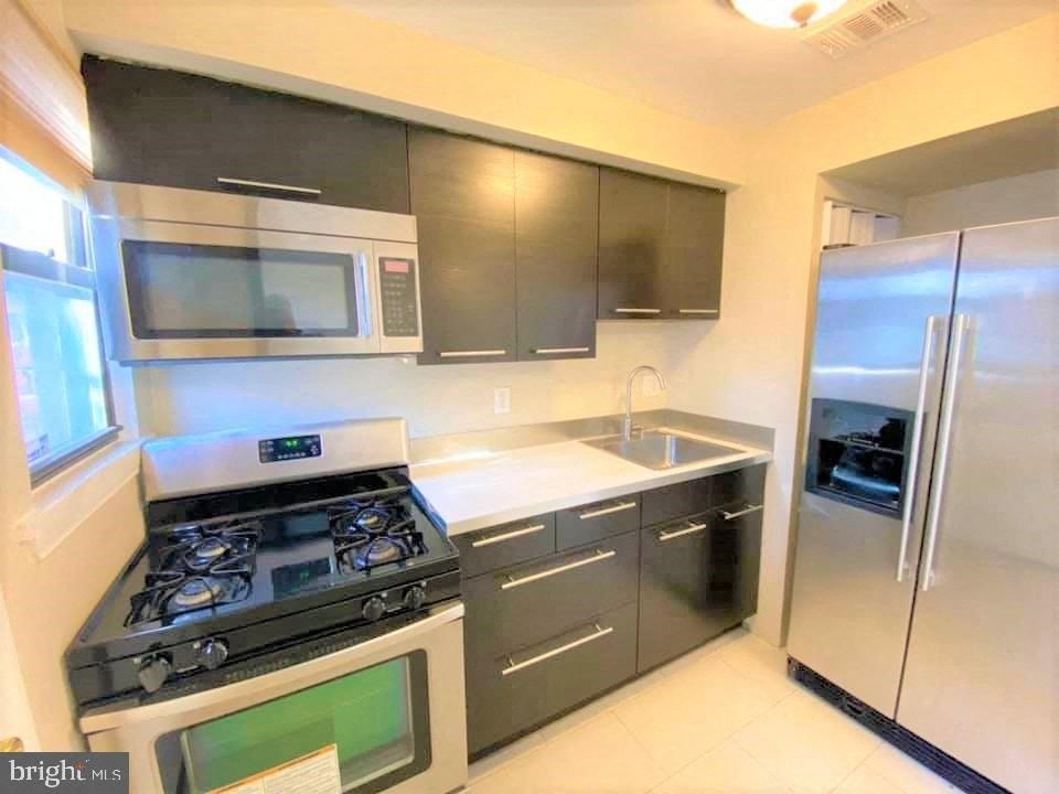 a kitchen with stainless steel appliances and a stove