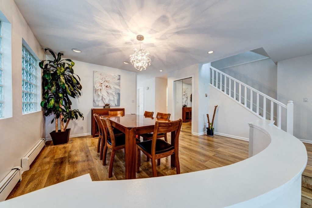 a dining room with a wooden table and a staircase