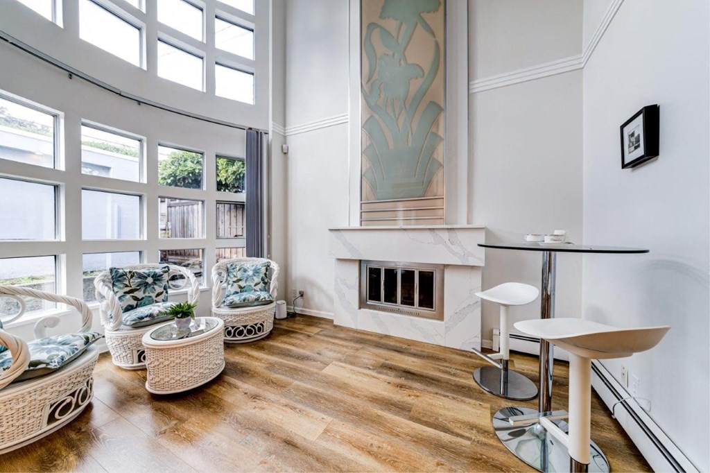 a living room with a fireplace and a large window