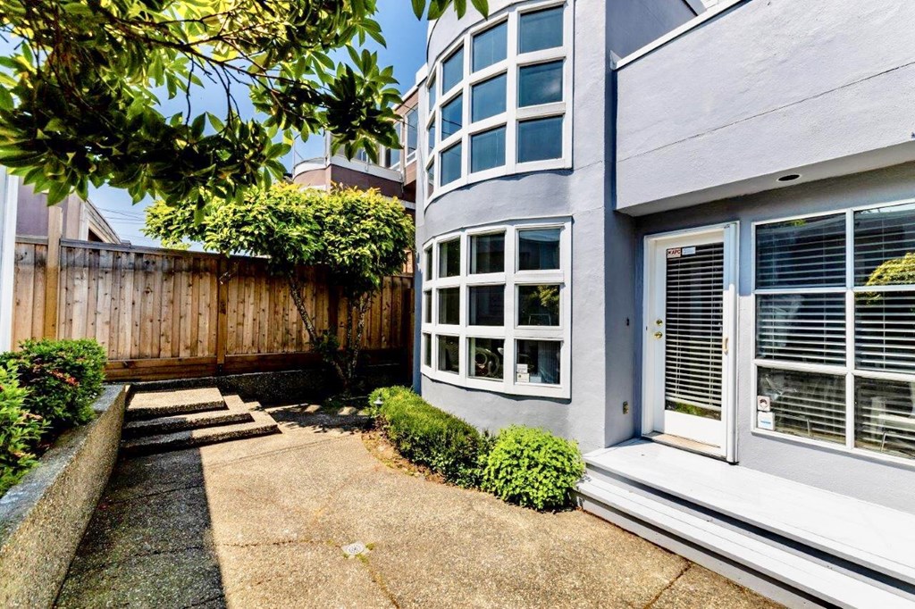 a side view of a house with a yard and a window