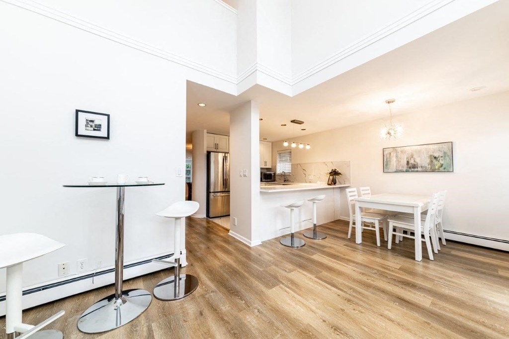 a dining room and kitchen with a table and chairs
