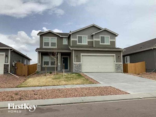 a house with a white garage door in front of a driveway