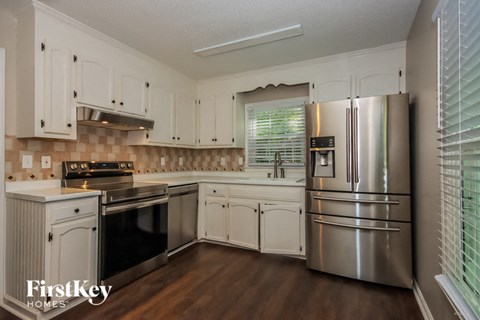 a kitchen with stainless steel appliances and white cabinets