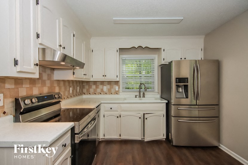 a kitchen with stainless steel appliances and white cabinets