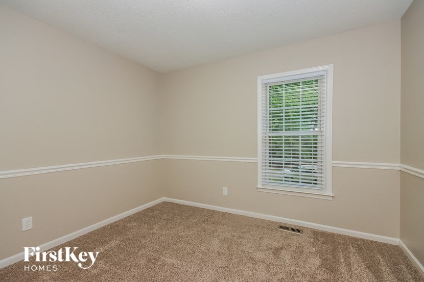 a empty room with a window and carpet