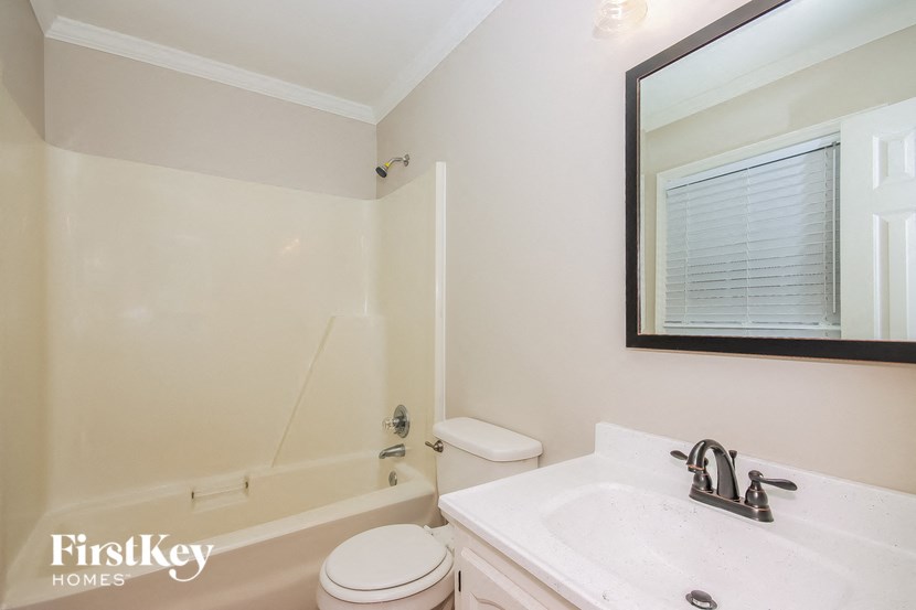 a bathroom with a sink toilet and a bath tub