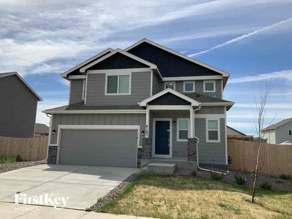 A two-story house with a garage is for sale by FirstKey Homes.
