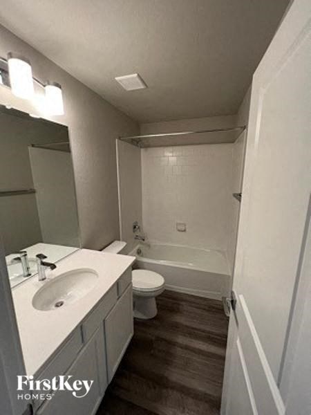 a white bathroom with a sink and a toilet