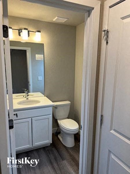 a bathroom with a toilet and a sink and a mirror