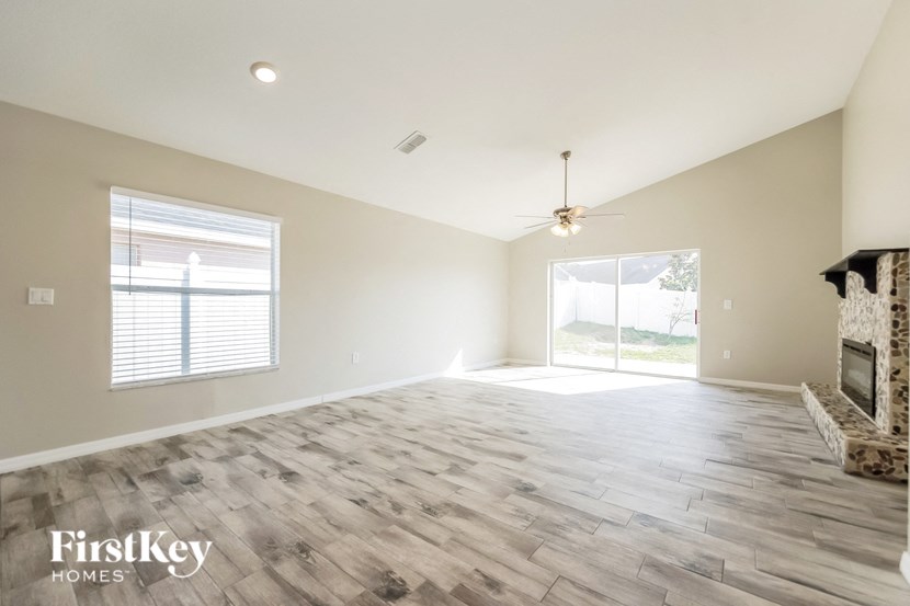 the living room is open to the dining room and fireplace
