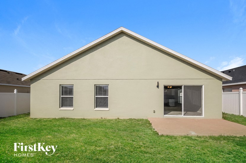 the front of a house with a lawn and a driveway