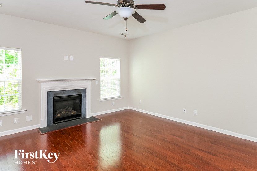 A room with a fireplace and a ceiling fan.