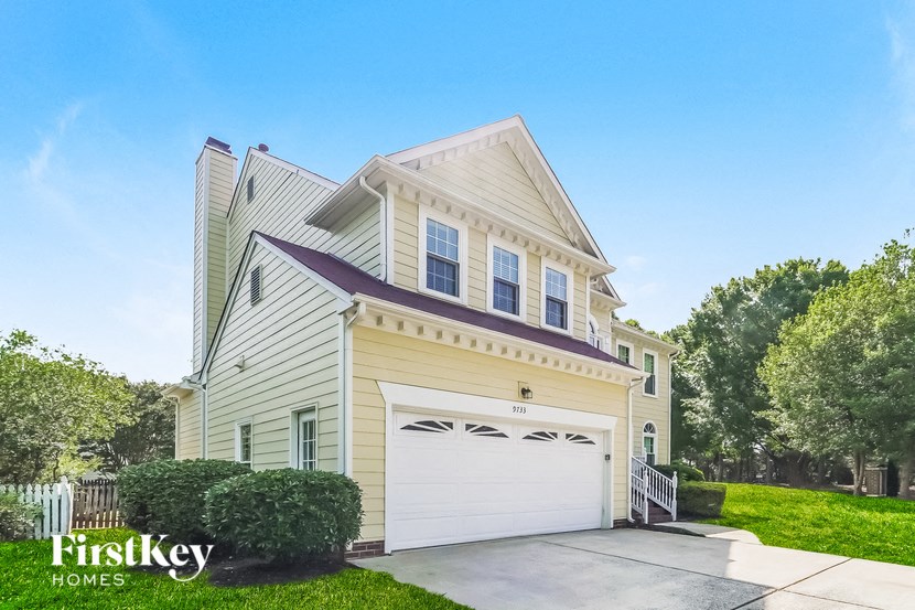 a white house with a white garage door