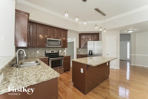 a kitchen with granite counter tops and stainless steel appliances