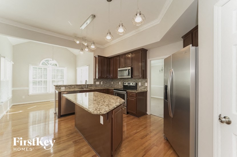 a kitchen with stainless steel appliances and granite counter tops