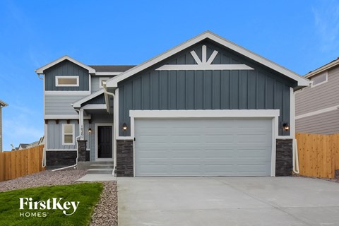 a gray house with a white garage door