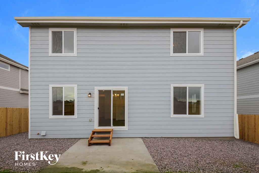 a blue house with a wooden bench in front of it