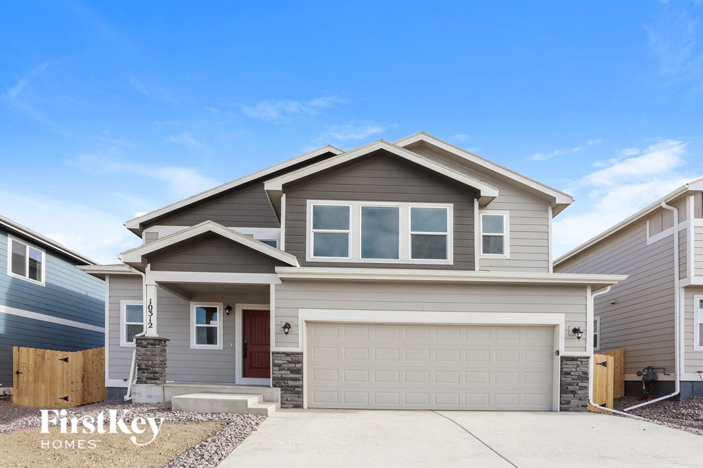 a gray house with a white garage door