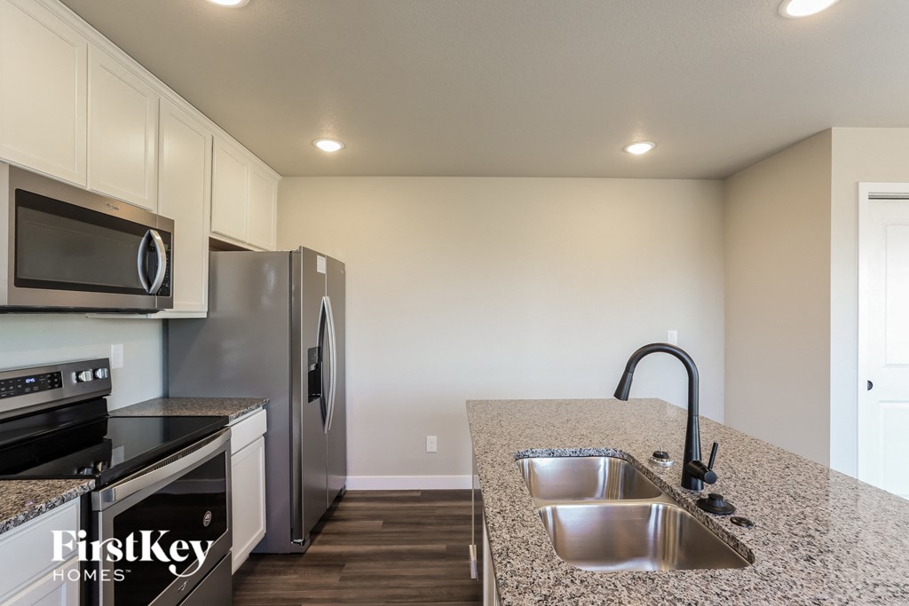 a kitchen with stainless steel appliances and granite counter tops