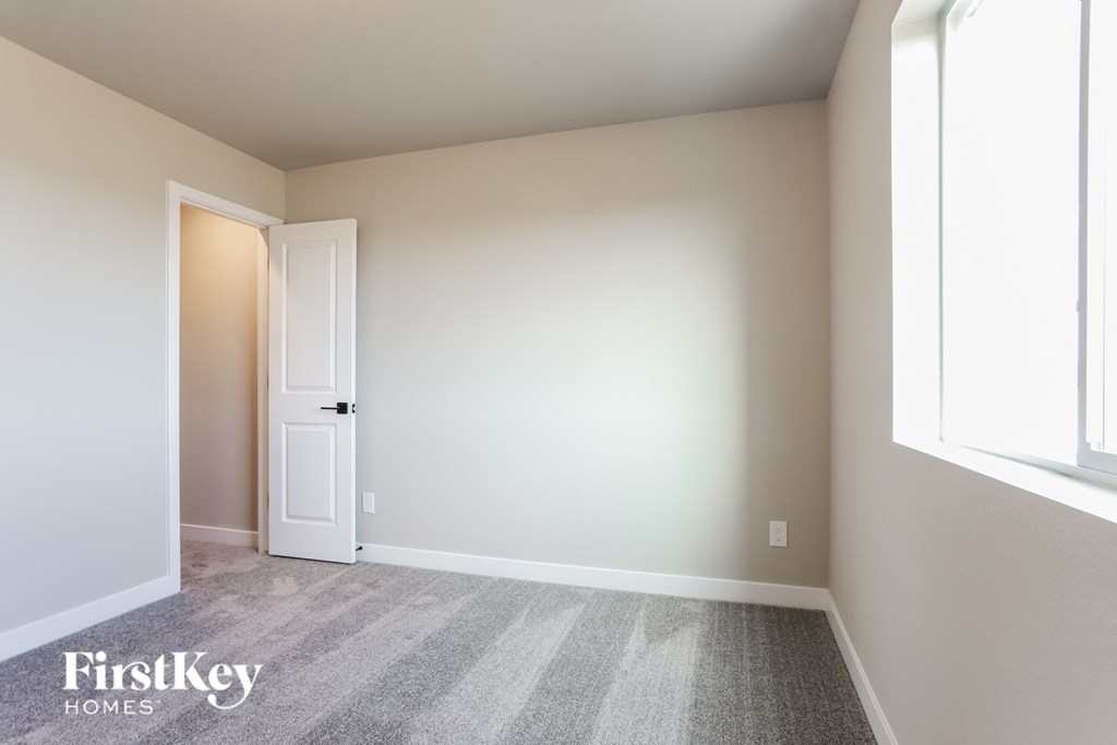 a blank room with a door and a carpeted floor