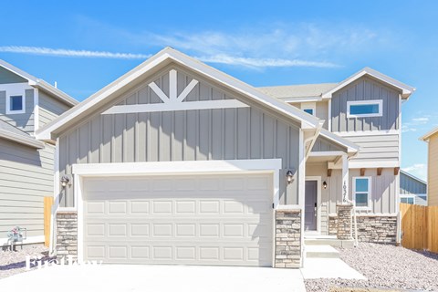 a gray house with a white garage door