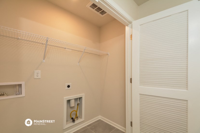 the laundry room has a large closet and a shower